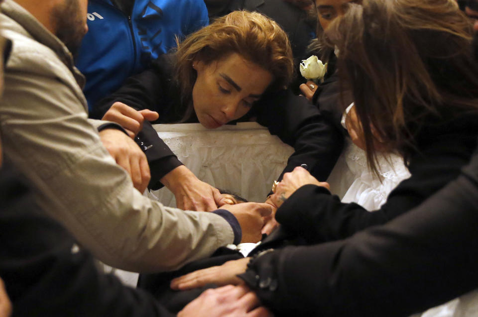 The sister of Elias Wardini, center, a Lebanese man who was killed in the New Year's Eve Istanbul nightclub attack, mourns over her brother's body during his funeral procession at a church, in Beirut, Lebanon, Tuesday, Jan. 3, 2017. The gunman killed 39 people, most of them foreigners, including three Lebanese citizens, at the Istanbul nightclub. The Islamic State group claimed the attack on Monday, saying a "soldier of the caliphate" had carried out the mass shooting in response to Turkish military operations against IS in northern Syria. (AP Photo/Hussein Malla)