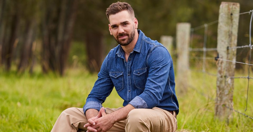 Farmer Sam sitting in grass