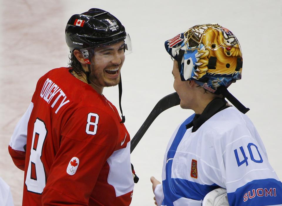 Canada's Drew Doughty laughs with Finland's goalie Tuukka Rask after Canada defeated Finland in overtime in their men's preliminary round ice hockey game at the 2014 Sochi Winter Olympics, February 16, 2014. REUTERS/Brian Snyder (RUSSIA - Tags: OLYMPICS SPORT ICE HOCKEY)