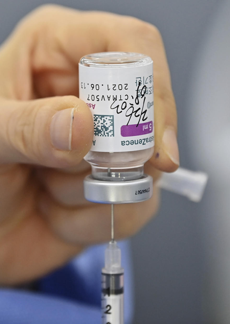 A nurse fills a syringe with the AstraZeneca COVID-19 vaccine at a health care center in Seoul Friday, Feb. 26, 2021. South Korea on Friday administered its first available shots of coronavirus vaccines to people at long-term care facilities, launching a mass immunization campaign that health authorities hope will restore some level of normalcy by the end of the year. (Jung Yeon-je /Pool Photo via AP)