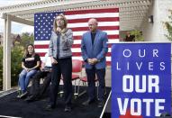 FILE - In this Oct. 2, 2018, file photo, former Rep. Gabby Giffords speaks as her husband, retired NASA astronaut and Navy Capt. Mark Kelly looks on as they kick off "The Vote Save Lives" tour at UNLV in Las Vegas. A Kelly victory would shrink the GOP's Senate majority at a crucial moment and complicate the path to confirmation for President Donald Trump's Supreme Court nominee. Kelly has maintained a consistent polling lead over Republican Sen. Martha McSally, who was appointed to the seat held by the late John McCain. (Bizuayehu Tesfaye/Las Vegas Review-Journal via AP, File)