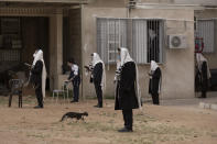 Ultra-Orthodox Jews keep social distancing during a morning prayer next to their houses as synagogues are closed following the government's measures to help stop the spread of the coronavirus, in Bnei Brak, Israel, April 24, 2020. (AP Photo/Oded Balilty)