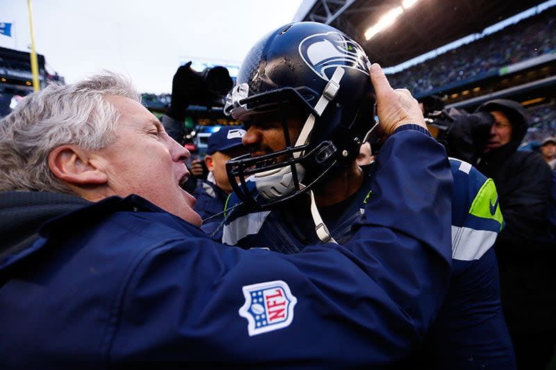 SEATTLE, WA - JANUARY 18: Head coach Pete Carroll and  Russell Wilson #3 of the Seattle Seahawks celebrate after the Seahawks 28-22 victory in overtime against the Green Bay Packers during the 2015 NFC Championship game at CenturyLink Field on January 18, 2015 in Seattle, Washington.  (Photo by Kevin C. Cox/Getty Images)