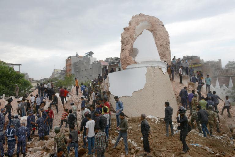 Nepalese rescue members gather at the collapsed Darahara Tower in Kathmandu, on April 25, 2015