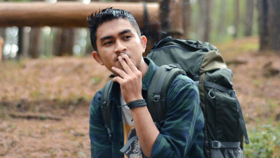 Backpacker smoking at campsite