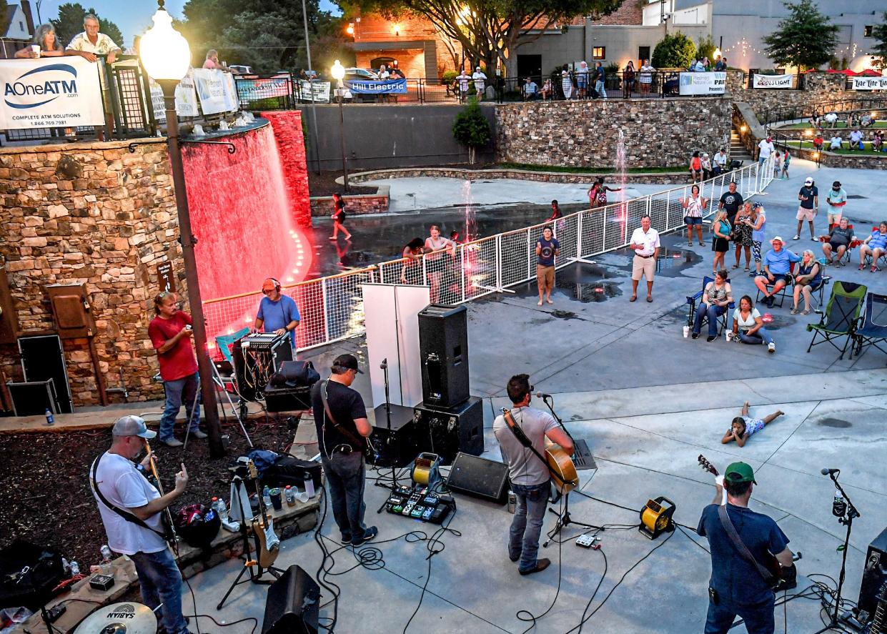 The Eric Scott Band plays at Carolina Wren Park during downtown evening activity in downtown Anderson Thursday, July 28, 2022. The band plays near many downtown restaurants with additional outdoor seating, and a splash pad near families seated to watch. 