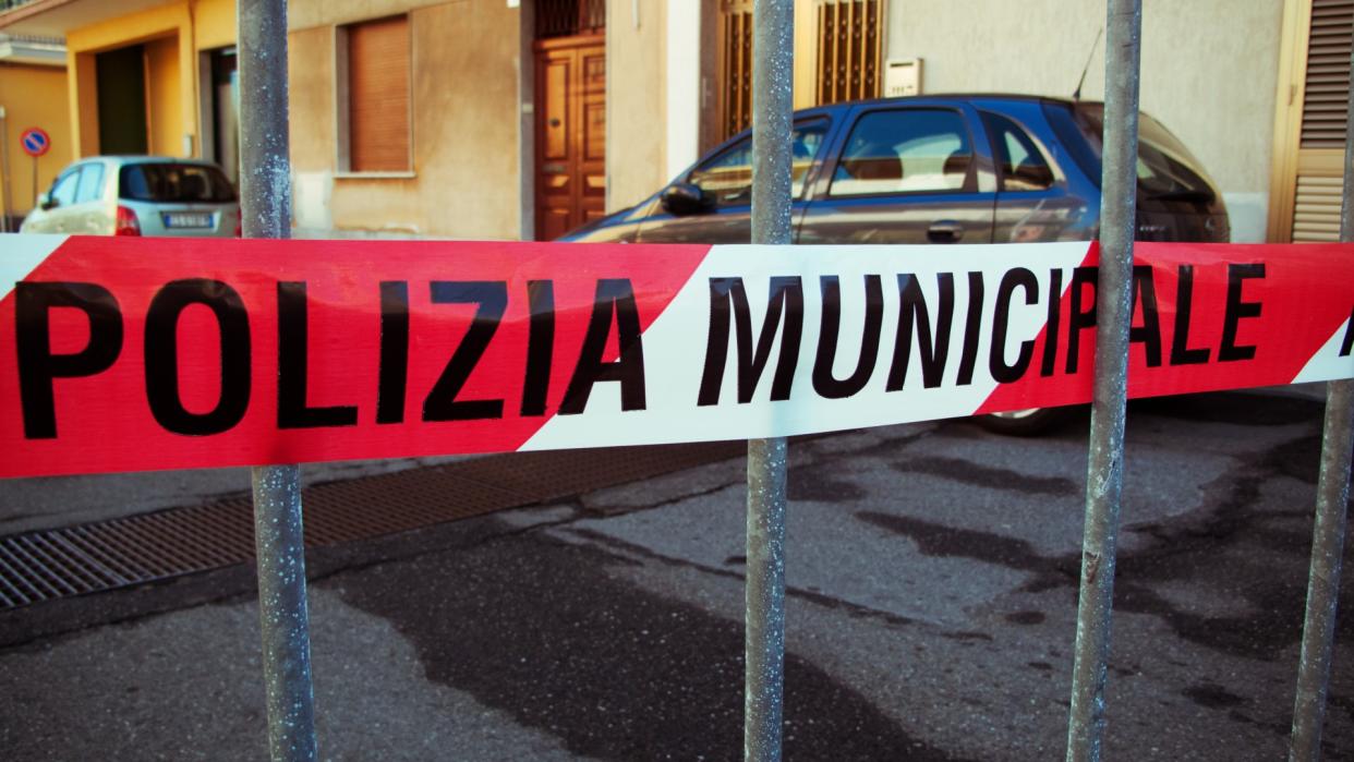  Police cordon tape in a street of a small town in Sicily, Italy. 