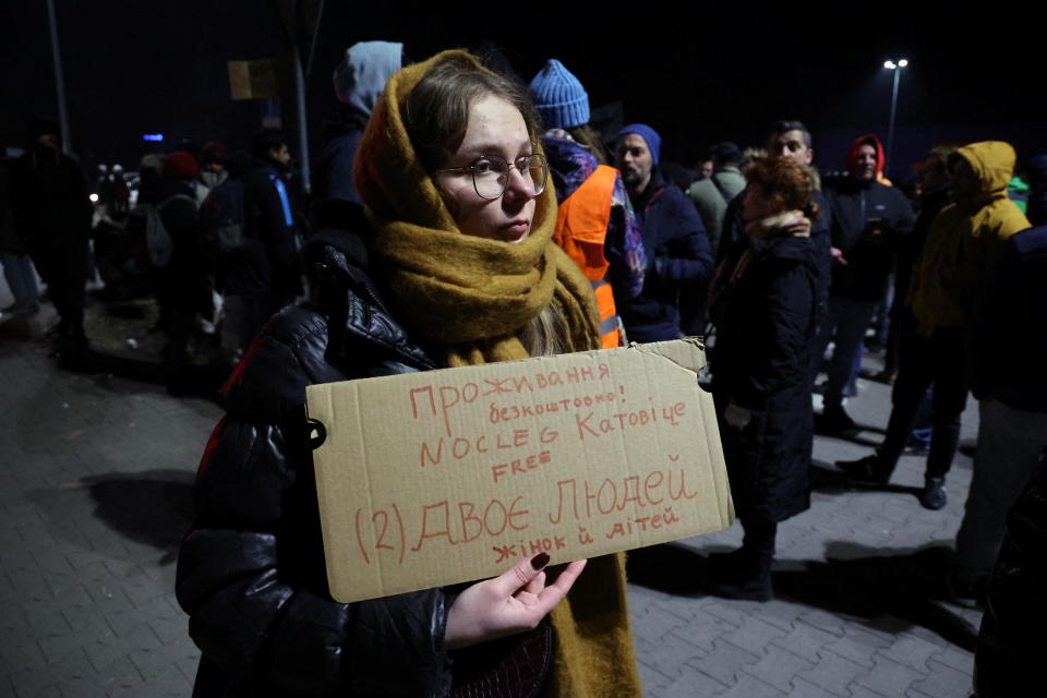 People wait in a parking lot for buses to arrive with refugees to help organise transportation and accommodation to different cities in Poland and other countries after Russia launched a massive military operation against Ukraine, in Przemysl, Poland February 26, 2022. REUTERS/Kacper Pempel