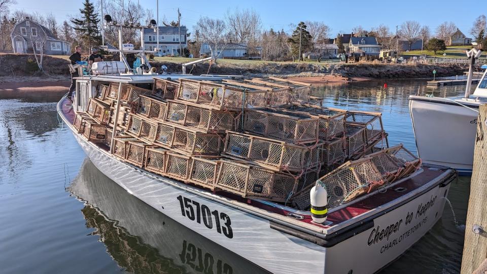 A lobster boat loaded with traps gets set to head into the Northumberland Strait.