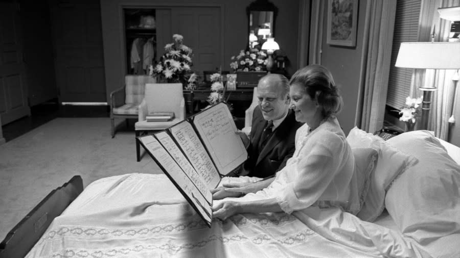 President and Mrs. Ford read a petition signed by all 100 members of the United States Senate following the First Lady’s surgery for breast cancer on Oct. 2, 1974, at the Bethesda Naval Hospital. (Courtesy Gerald R. Ford Presidential Library & Museum)