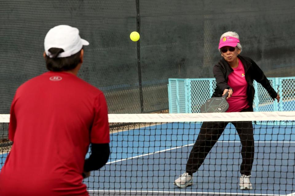 Dr. Loida Medina, 85, right, plays a game of pickleball with her son Ernie Medina, 58,