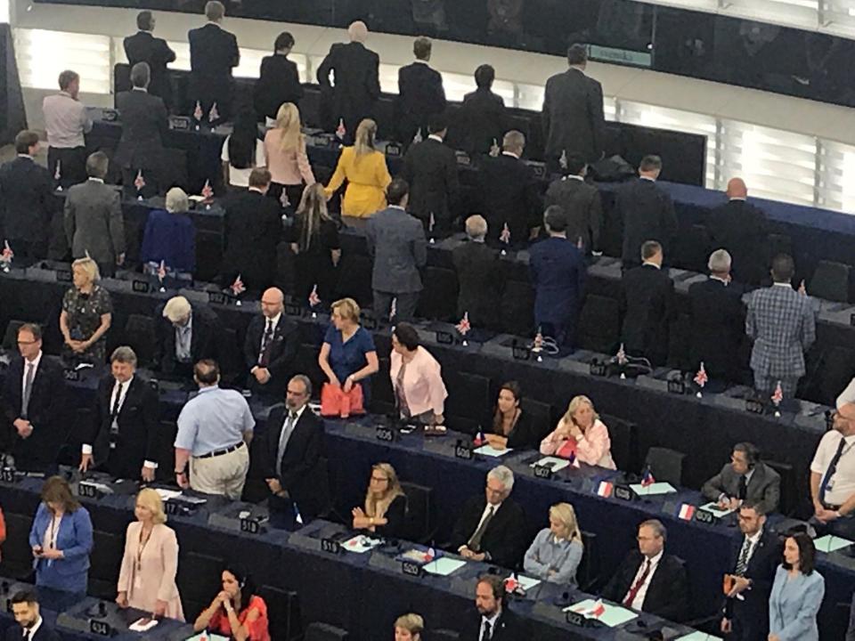 MEPs from Nigel Farage's Brexit Party have kicked off their time in the European Parliament by turning their backs on the EU's national anthem during the legislature's opening ceremony.The Brexiteers carried out the protest as Ode to Joy played on Tuesday morning to open the new parliamentary session.They were far from the only British delegation to pull a stunt, however. The newly enlarged Liberal Democrat contingent from the UK turned up to the first sitting of the parliament wearing identical yellow "Bollocks to Brexit" t-shirts.Richard Corbett, a long-serving Labour MEP, said the Brexiteers "think they’re being clever by standing with their backs to the chair at the opening session", adding that the move "looks pathetic and [has] not impressed anyone".More follows…