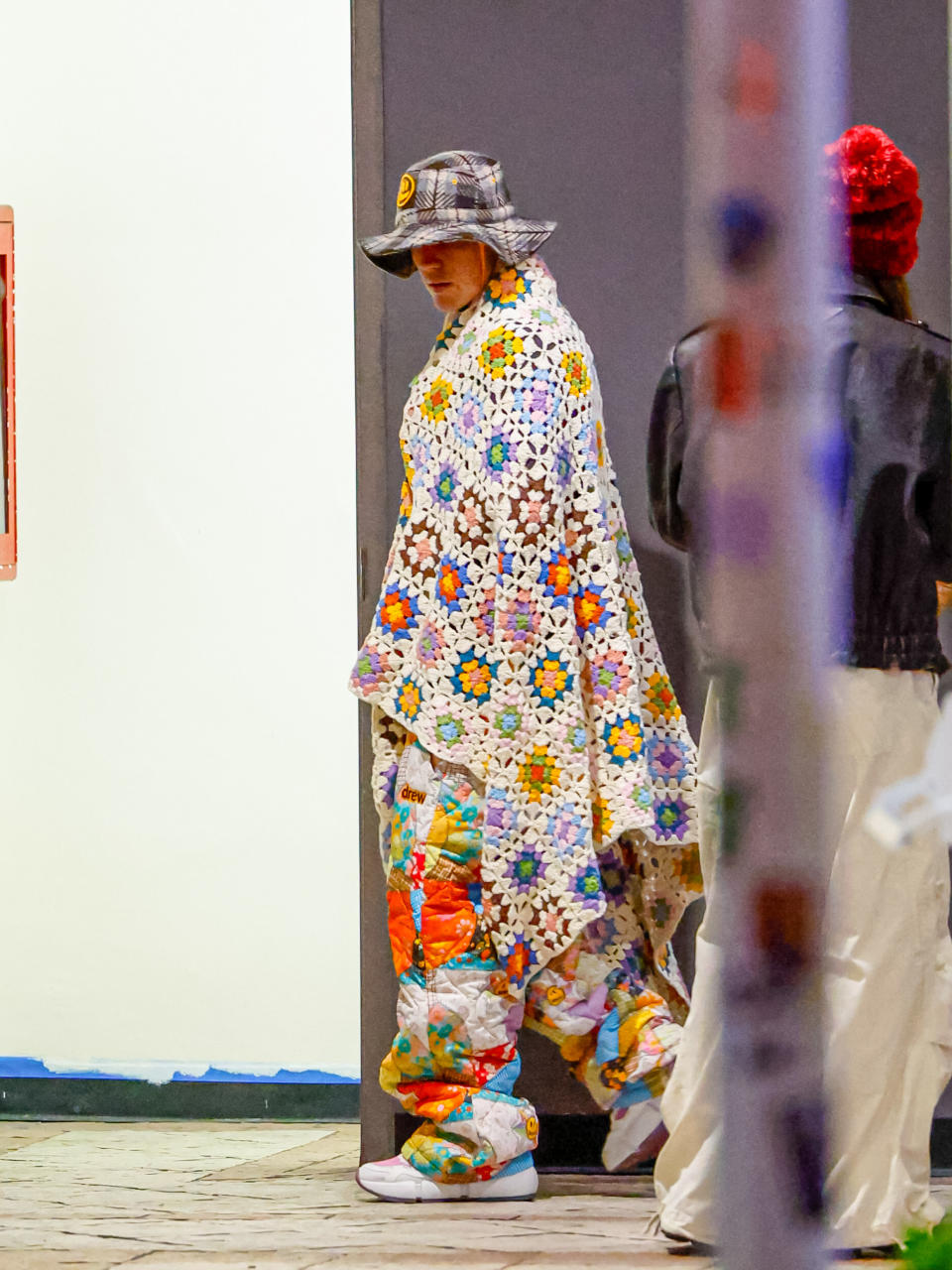 justin walking with a floral embroidered blanket