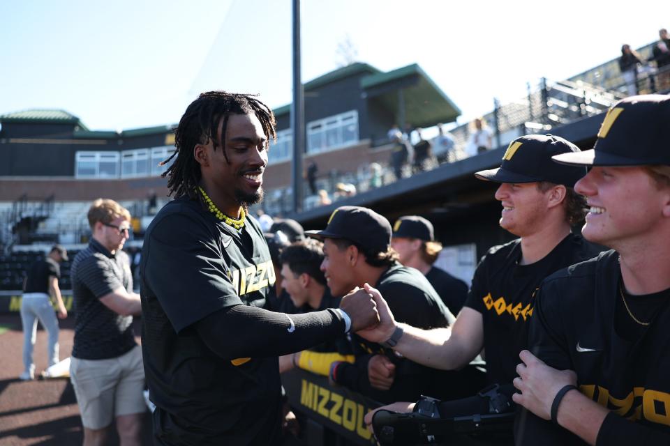 Missouri leadoff hitter Jeric Curtis celebrates with the team after his walk-off single to beat Florida on Sunday at Taylor Stadium in Columbia.