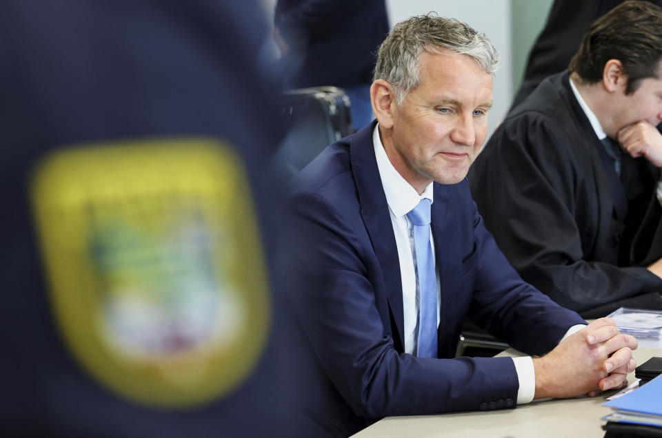 German far-right politician of the Alternative for Germany (AfD) Bjoern Hoecke, centre, attends his trial in the state court in Halle, Germany, Thursday, April 18, 2024. Bjoern Hoecke, goes on trial at the state court in Halle on charges related to his alleged use in a 2021 speech of a slogan used by the Nazis' SA stormtroopers. (Fabrizio Bensch/Pool via AP)