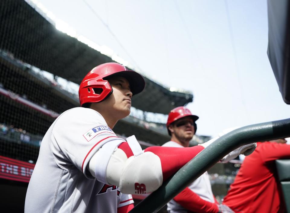 Angels star Shohei Ohtani stands in the dugout before a win against the Seattle Mariners on Wednesday.