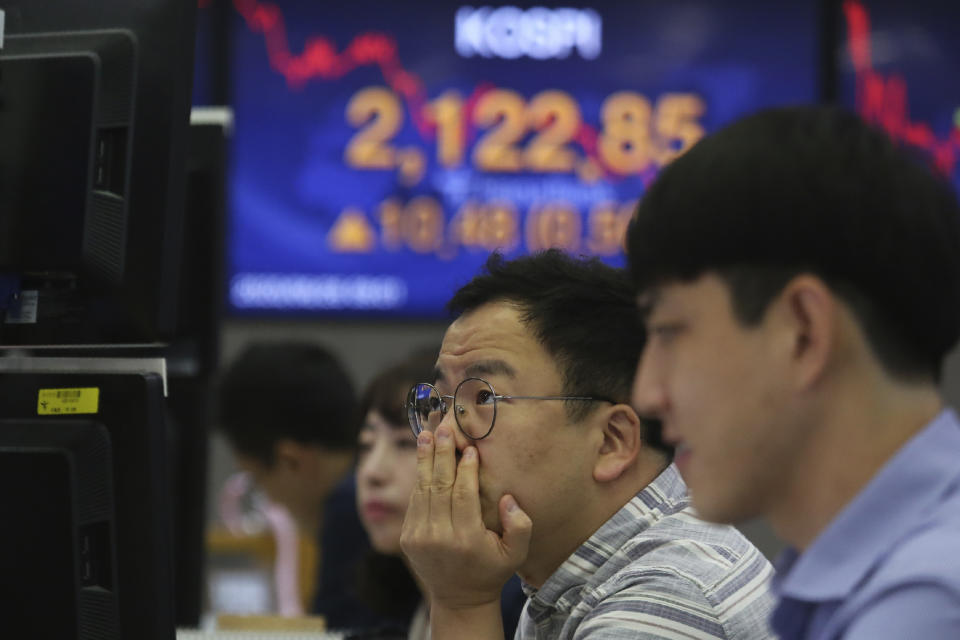 A currency trader watches monitors at the foreign exchange dealing room of the KEB Hana Bank headquarters in Seoul, South Korea, Friday, June 26, 2020. Asian stock markets followed Wall Street higher on Friday after U.S. regulators removed some limits on banks' ability to make investments. (AP Photo/Ahn Young-joon)