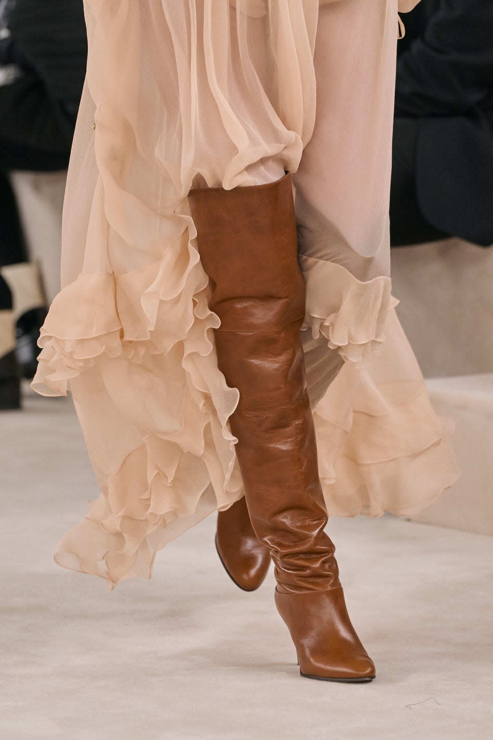 lady in peach dress with brown boots