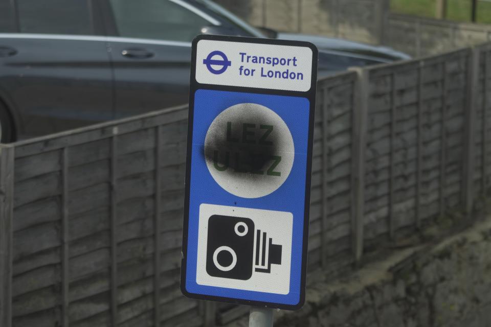 A road sign indicating the Ultra-Low Emission Zone (ULEZ) is defaced, in London, Tuesday, Aug. 29, 2023. London's traffic cameras are under attack. Police say hundreds of license-plate reading cameras have been damaged, disconnected or stolen by opponents of an anti-pollution charge on older vehicles that comes into force across the metropolis on Tuesday. (AP Photo/Kin Cheung)