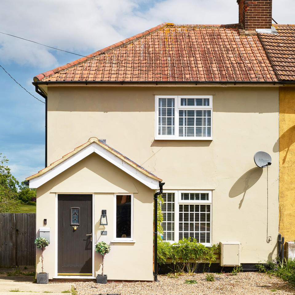 Yellow painted rendered house with red roof tiles