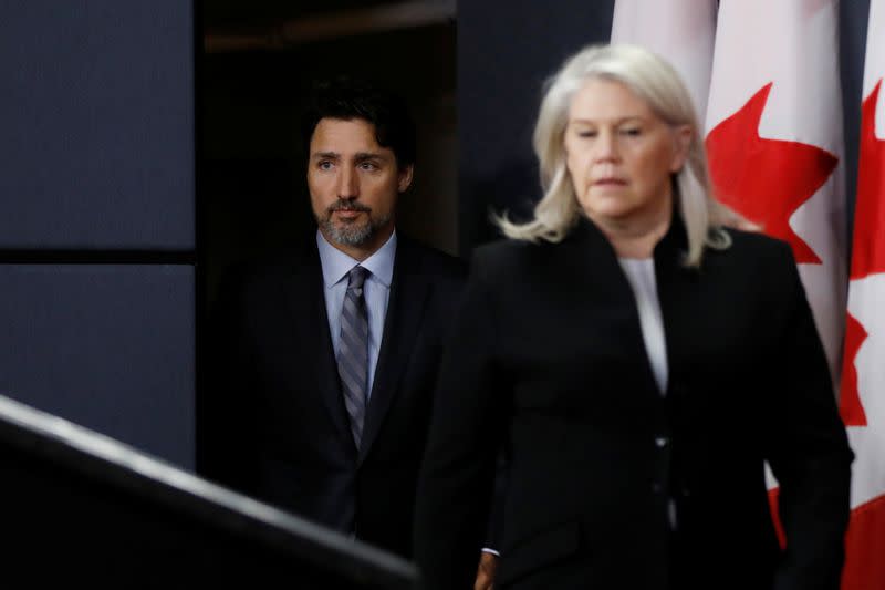 Canada's Prime Minister Justin Trudeau arrives to a news conference, with Deputy Minister of National Defence Jody Thomas, in Ottawa