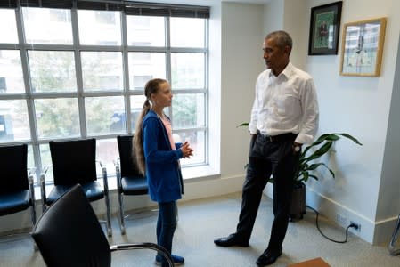 Former U.S. President Barack Obama talks with Greta Thunberg during a meeting at his personal office in Washington