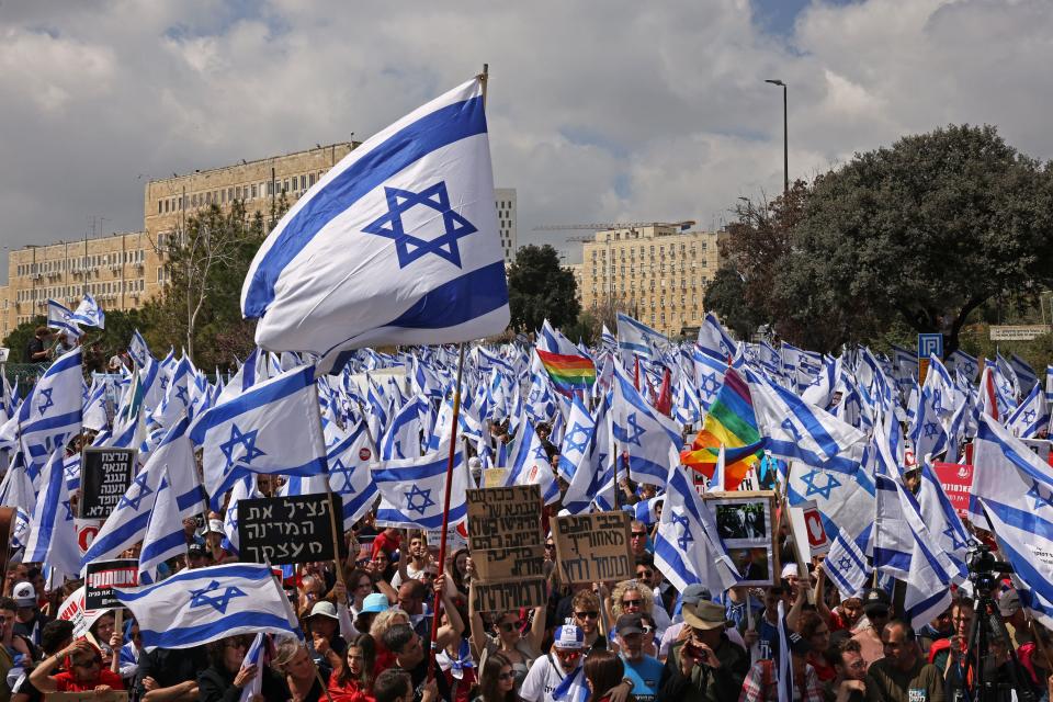 Protesters gather outside Israel's parliament in Jerusalem amid ongoing demonstrations and calls for a general strike against the hard-right government's controversial push to overhaul the justice system, on March 27, 2023.