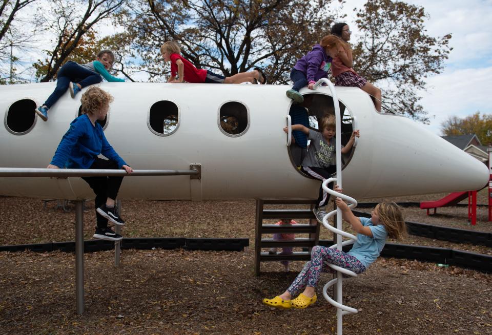 Kids from P.E.A.C.E. Homeschool Group play on the airplane at West Side Nut Club Park in Evansville, Ind., Friday afternoon, Nov. 4, 2022. 