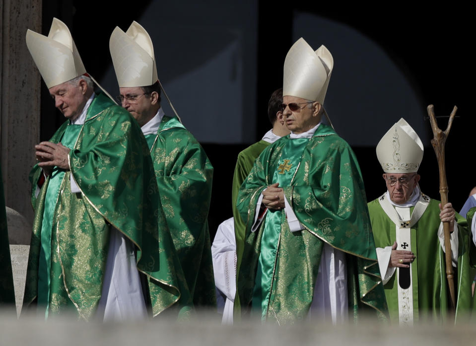 FILE - Pope Francis, bottom right, arrives to celebrate a Mass for the opening of a synod, a meeting of bishops, in St. Peter's Square, at the Vatican, Wednesday, Oct. 3, 2018. The synod is bringing together 266 bishops from five continents for talks on helping young people feel called to the church at a time when church marriages and religious vocations are plummeting in much of the West. Pope Francis is convening a global gathering of bishops and laypeople to discuss the future of the Catholic Church, including some hot-button issues that have previously been considered off the table for discussion. Key agenda items include women's role in the church, welcoming LGBTQ+ Catholics and how bishops exercise authority. For the first time, women and laypeople can vote on specific proposals alongside bishops. (AP Photo/Alessandra Tarantino, File)