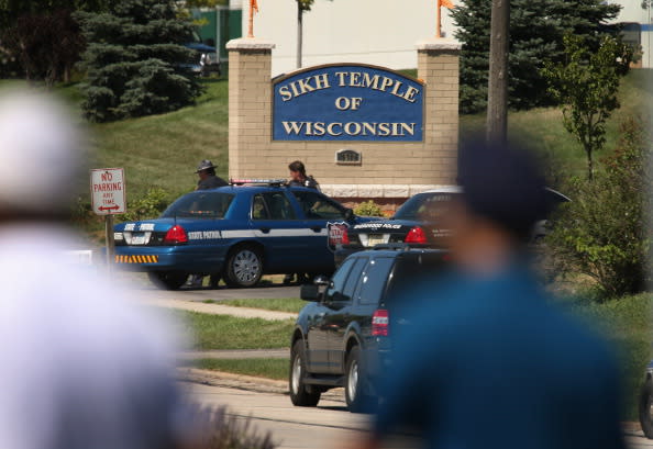 Police guard the front of the Sikh Temple of Wisconsin where at least one gunman fired upon people at a service August, 5, 2012 Oak Creek, Wisconsin. At least six people were killed when a shooter, who was later shot dead by a police officer, opened fire on congregants in the Milwaukee suburb. (Photo by Scott Olson/Getty Images)