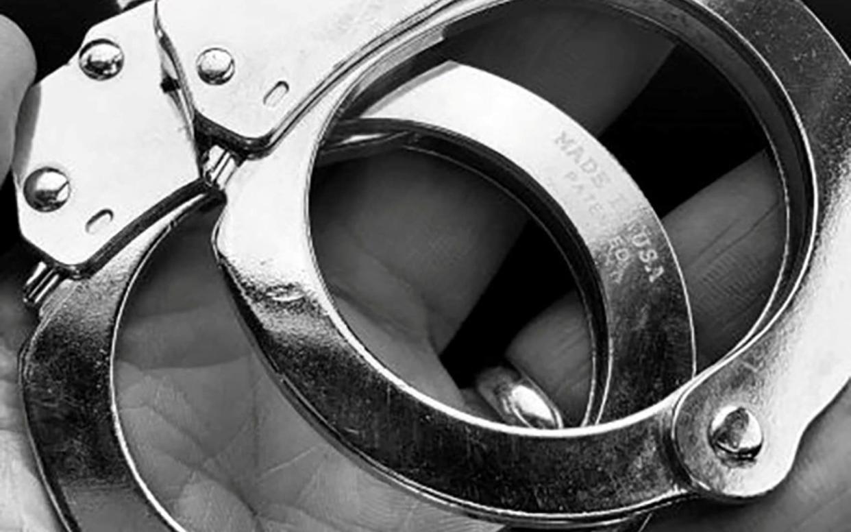 The handcuffs of slain Boulder Police Officer Eric Talley, who was killed in the King Soopers grocery story shooting, are seen after police said they were used to process the suspect into custody at the county jail, in a photograph posted on the police force's Twitter account in Boulder, Colorado, U.S. March 25, 2021. Boulder Police/Handout via REUTERS. NO RESALES. NO ARCHIVES. THIS IMAGE HAS BEEN SUPPLIED BY A THIRD PARTY. - Reuters