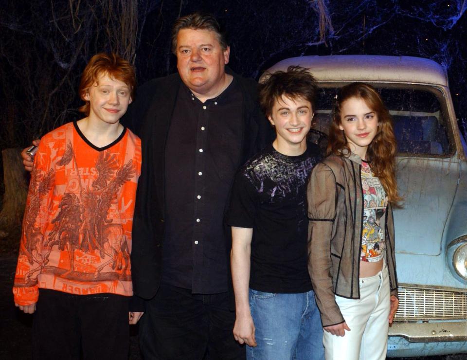 The stars of Harry Potter and the Chamber of Secrets, from left to right; Rupert Grint, Robbie Coltrane, Daniel Radcliffe Emma Watson during the worldwide launch of the DVD/VHS at Leavesden Studios in north London. (Photo by Yui Mok – PA Images/PA Images via Getty Images)