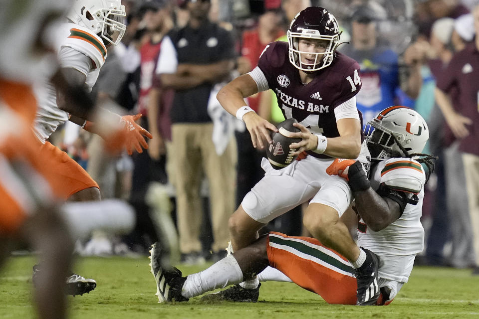 Miami defensive lineman Jahfari Harvey (12) sacks Texas A&M quarterback Max Johnson (14) during the second quarter of an NCAA college football game Saturday, Sept. 17, 2022, in College Station, Texas. (AP Photo/Sam Craft)