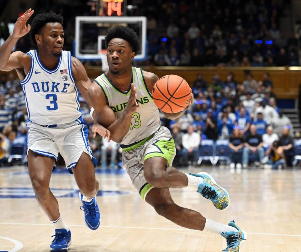 Dec 30, 2023; Durham, North Carolina, USA; Queens Royals guard Deyton Albury (13) drives to the basket as Duke Blue Devils guard Jeremy Roach (3) defends during the first half at Cameron Indoor Stadium. Mandatory Credit: Rob Kinnan-USA TODAY Sports