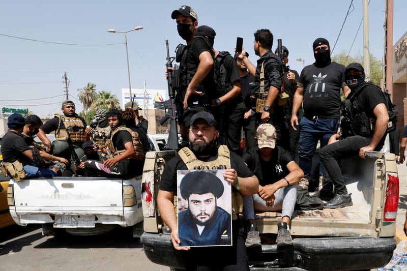 FILE PHOTO: Followers of Iraqi cleric Moqtada al-Sadr withdraw from the streets after violent clashes, near the Green Zone in Baghdad