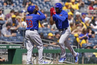 Chicago Cubs' Jeimer Candelario celebrates with third base coach Willie Harris as he rounds the bases after hitting a two-run home run against the Pittsburgh Pirates in the fourth inning of a baseball game in Pittsburgh, Sunday, Aug. 27, 2023. (AP Photo/Matt Freed)