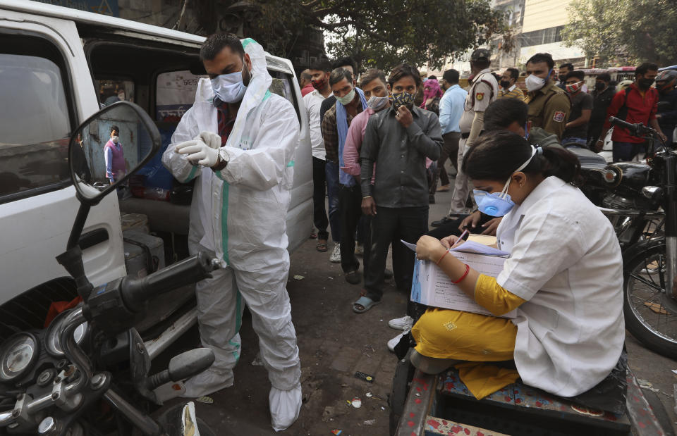 A health worker gears up to collect samples to test for COVID-19 in New Delhi, India, Thursday, Nov. 19, 2020. Nevertheless the country’s new daily cases have seen a steady decline for weeks now and the total number of cases represents 0.6% of India’s 1.3 billion population. (AP Photo/Manish Swarup)