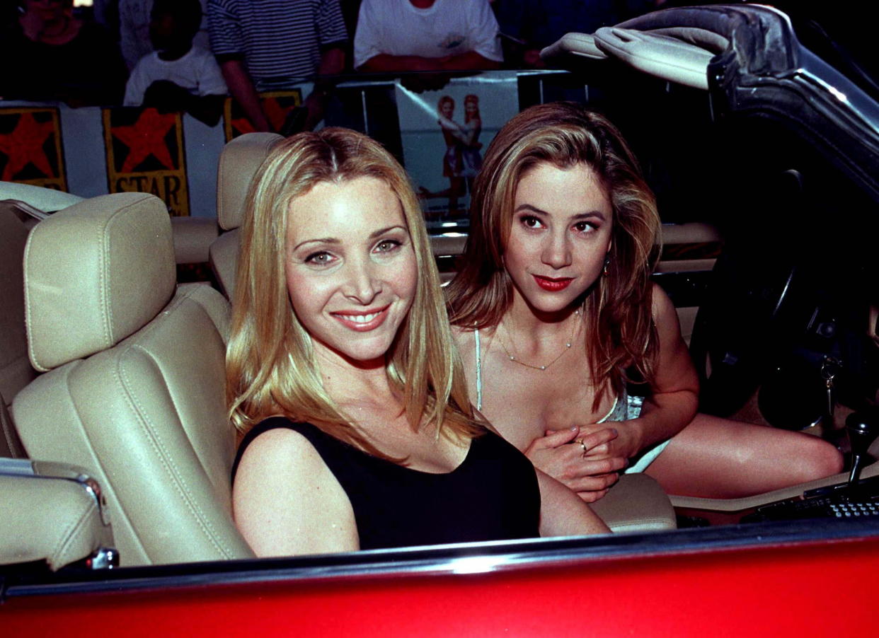 American Actresses Lisa Kudrow (L) and Mira Sorvino pose as they arrive in a Jaguar convertible April 25 for the premiere of their new film 