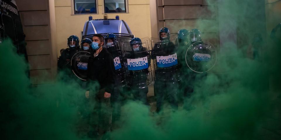 Demonstrators clash with Riot Police during the protest against the lockdown in Piazza Castello on October 26, 2020 in Turin, Italy. The protest is organized to protest against the blockade to restaurant and bars and curfew imposed in the Piedmont Region and by the Italian Government of the evening lockdown which will start from today at 6pm to contain the coronavirus pandemic. (Photo by Mauro Ujetto/NurPhoto via Getty Images)