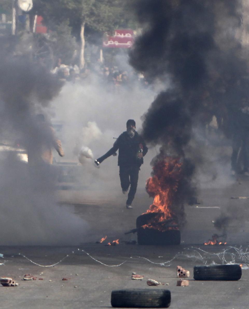 Supporters and opponents of ousted President Mursi clash at Nasr City district in Cairo