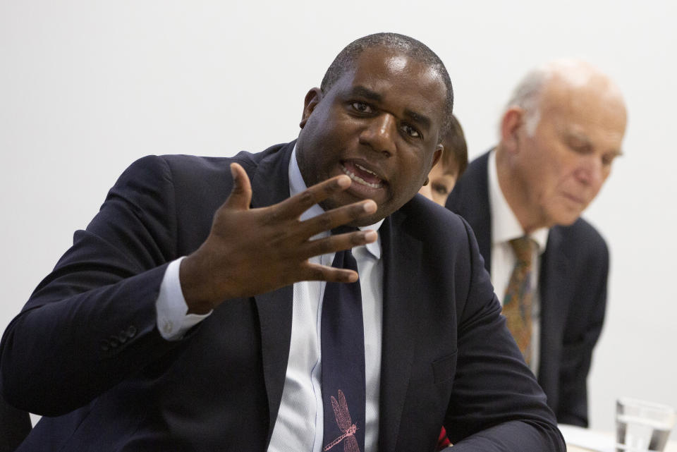 FILE - In this Wednesday, Oct. 16, 2019 file photo, British Labour Party MP David Lammy, brought to Brussels by the campaign group Best for Britain, speaks to the media at the IPC building in Brussels. British Prime Minister Boris Johnson will establish a commission to look at racial equality in the U.K. The move comes after two weeks of protests spurred by the death of George Floyd in Minneapolis by police. Opposition Labour Party lawmaker David Lammy accused the Conservative government of stalling. He said "the time for review is over and the time for action is now.” (AP Photo/Virginia Mayo, File)