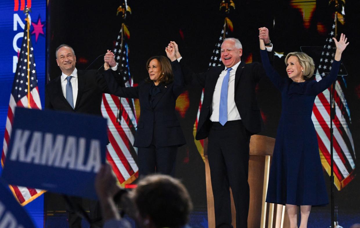 Kamala Harris, her husband Doug Emhoff, Tim Walz, and his wife Gwen stand onstage on the fourth day of the Democratic National Convention in Chicago on August 24. (REUTERS)