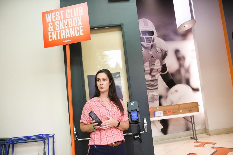 Alicia Longworth, Tennessee's executive associate athletics director of external operations, demonstrates the new digital ticketing system at Neyland Stadium. No paper tickets will be accepted this year, and fans are encouraged to get their tickets ready before going to the game.
