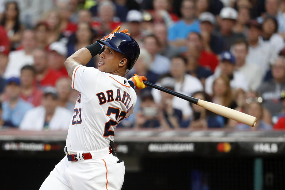 American League's Michael Brantley, of the Houston Astros, follows through on an RBI double during the second inning of the MLB baseball All-Star Game against the National League, Tuesday, July 9, 2019, in Cleveland. (AP Photo/John Minchillo)