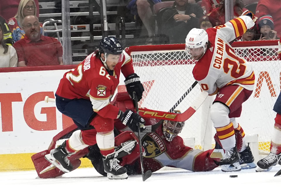 Florida Panthers goaltender Anthony Stolarz, center, makes a save in front of Calgary Flames center Blake Coleman (20) during the second period of an NHL hockey game, Saturday, March 9, 2024, in Sunrise, Fla. (AP Photo/Lynne Sladky)