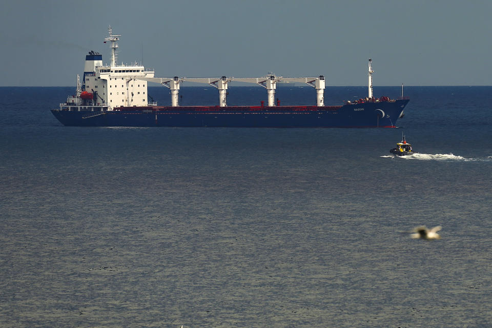 FILE - A boat with Russian, Ukrainian, Turkish and U.N. officials heads to the Sierra Leone-flagged cargo ship Razoni, to check if the grain shipment is in accordance with a crucial agreement signed last month by Moscow and Kyiv, at an inspection area in the Black Sea off the coast of Istanbul, Turkey, on Aug. 3, 2022. Russia has repeatedly fired missiles and drones at Ukrainian ports key to sending grain to the world. Moscow has declared large swaths of the Black Sea dangerous for shipping. (AP Photo/Emrah Gurel, File)