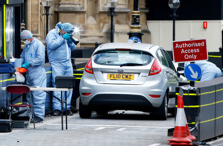 Forensic investigators work at the site after a car crashed outside the Houses of Parliament in Westminster, London, Britain, August 14, 2018. REUTERS/Henry Nicholls