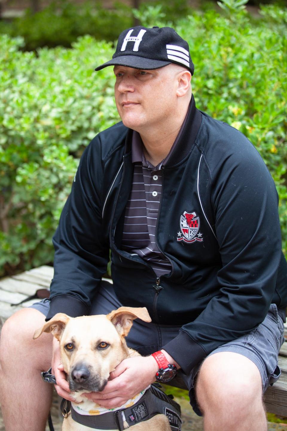 Kiowa Wolfe is photographed with his dog Marlow at Kadima Neuropsychiatry Institute in La Jolla, April 22, 2021.