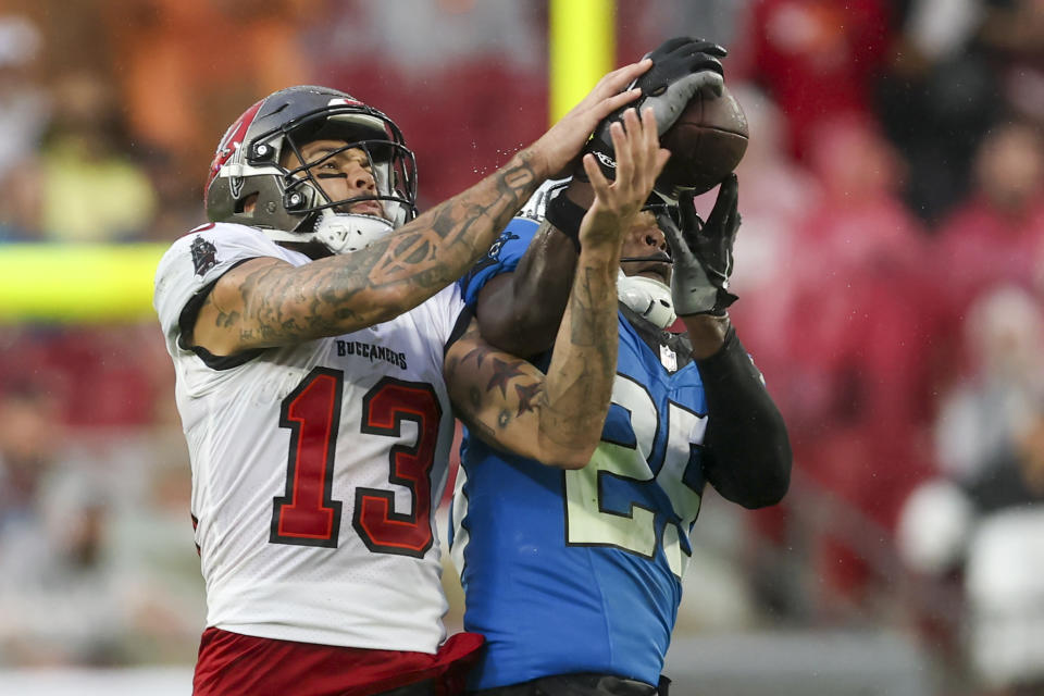 Carolina Panthers safety Xavier Woods intercepts a pass intended for Tampa Bay Buccaneers wide receiver Mike Evans during the first half of an NFL football game Sunday, Dec. 3, 2023, in Tampa, Fla. (AP Photo/Mark LoMoglio)