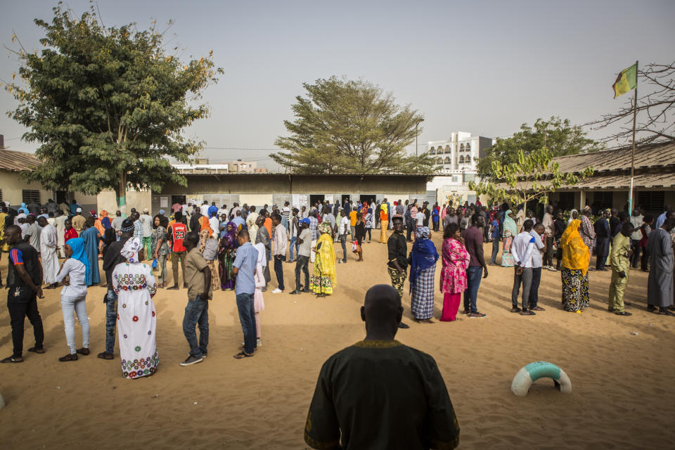 Senegalese voters line up to cast their votes at a polling station in Dakar, Senegal, Sunday Feb. 24, 2019. Voters are choosing whether to give President Macky Sall a second term in office as he faces four challengers. (AP Photo/Jane Hahn)